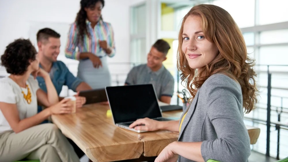 Image of a succesful casual business woman using laptop during meeting-1