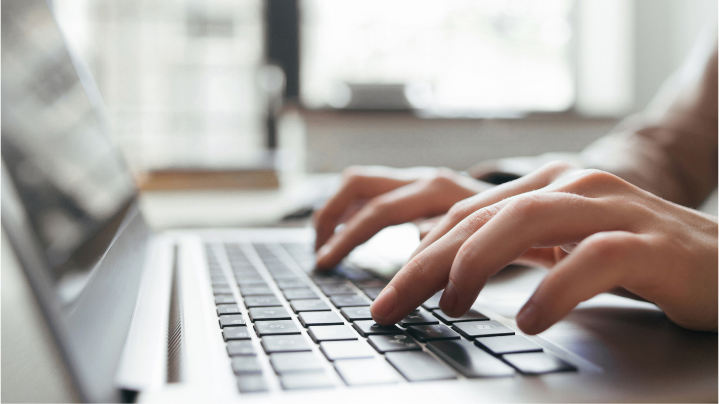 person typing on computer keyboard