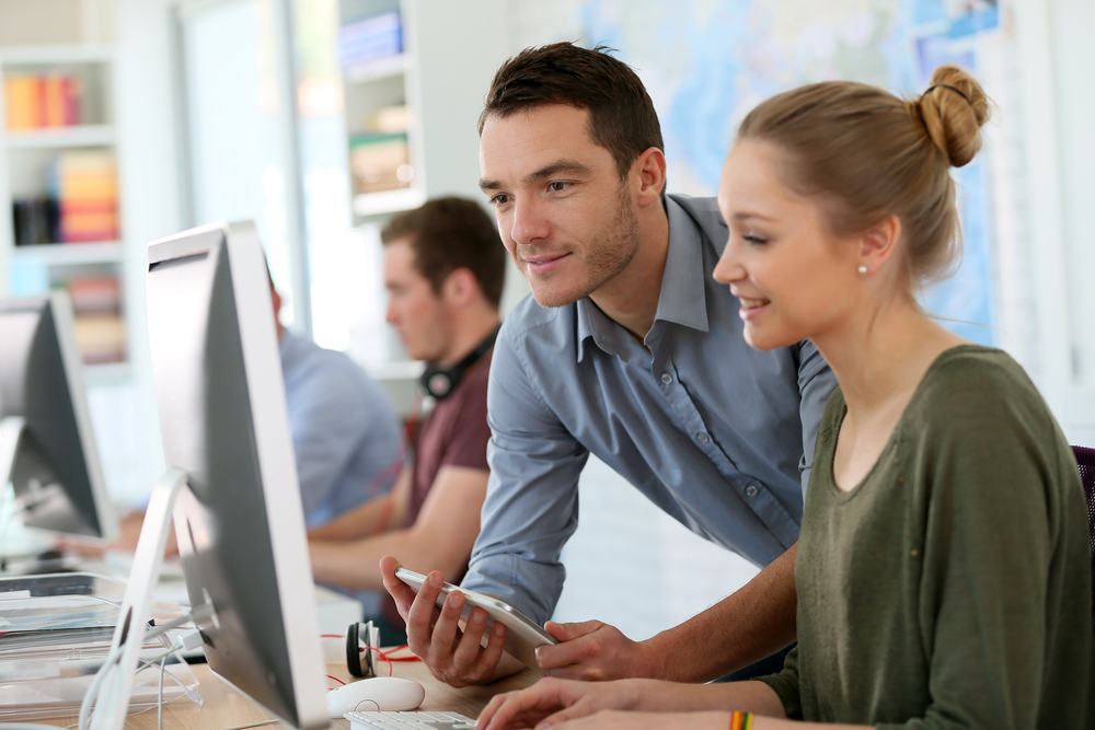 Student girl with a trainer working on computer and tablet